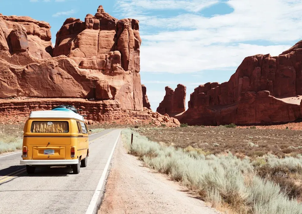 Open road winding toward a distant mountain horizon
